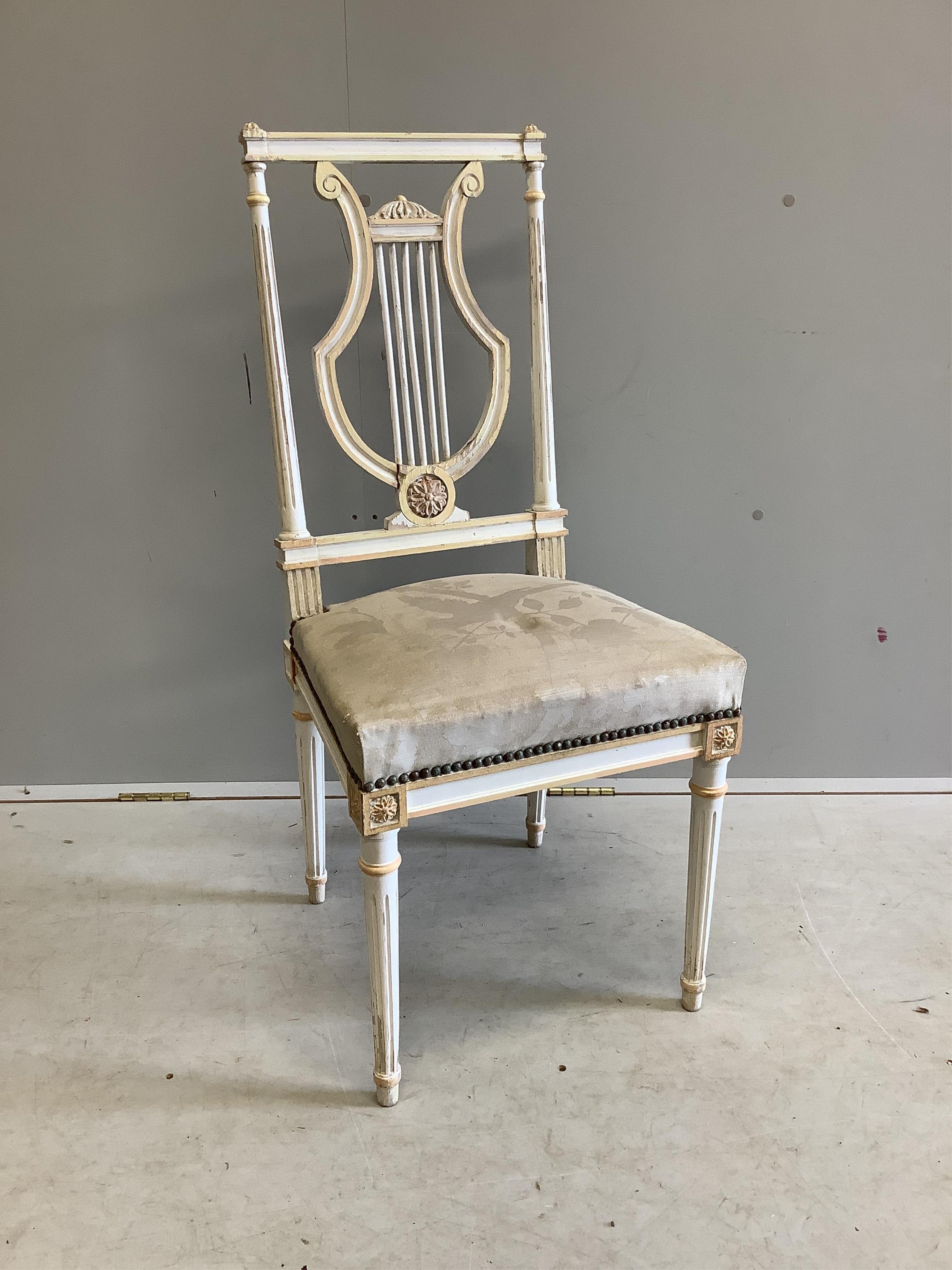 A set of eight Empire style painted lyre back chairs, width 43cm, height 99cm. Condition - fair